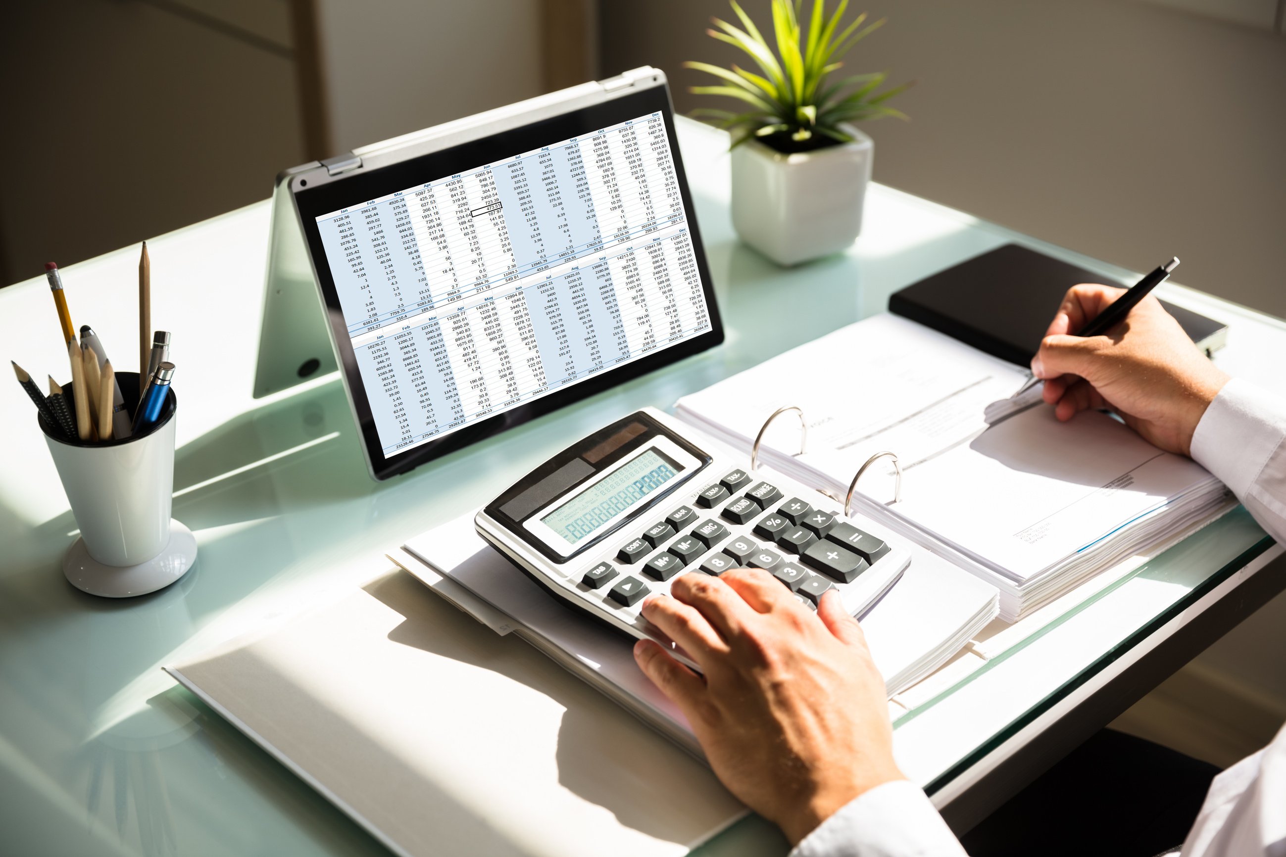 Businessman calculating invoice using calculator